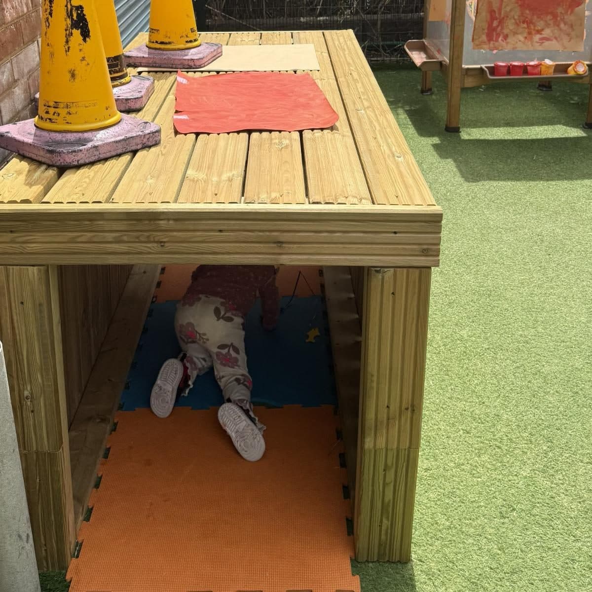 destiny haven nursery child under wooden table structure