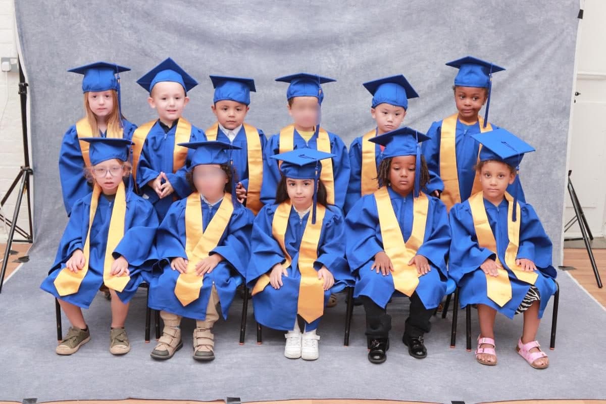 Destiny Haven Nursery children pose together in graduation caps and gown